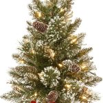 2-foot pre-lit mini glittery pine Christmas tree, features pinecones and a fabric base